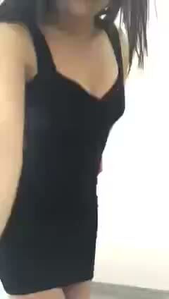 Curvy Brunette in Tight Black Dress Poses Seductively