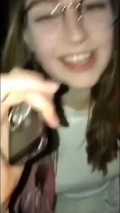 Brunette Teen with Glasses Smiles in Selfie