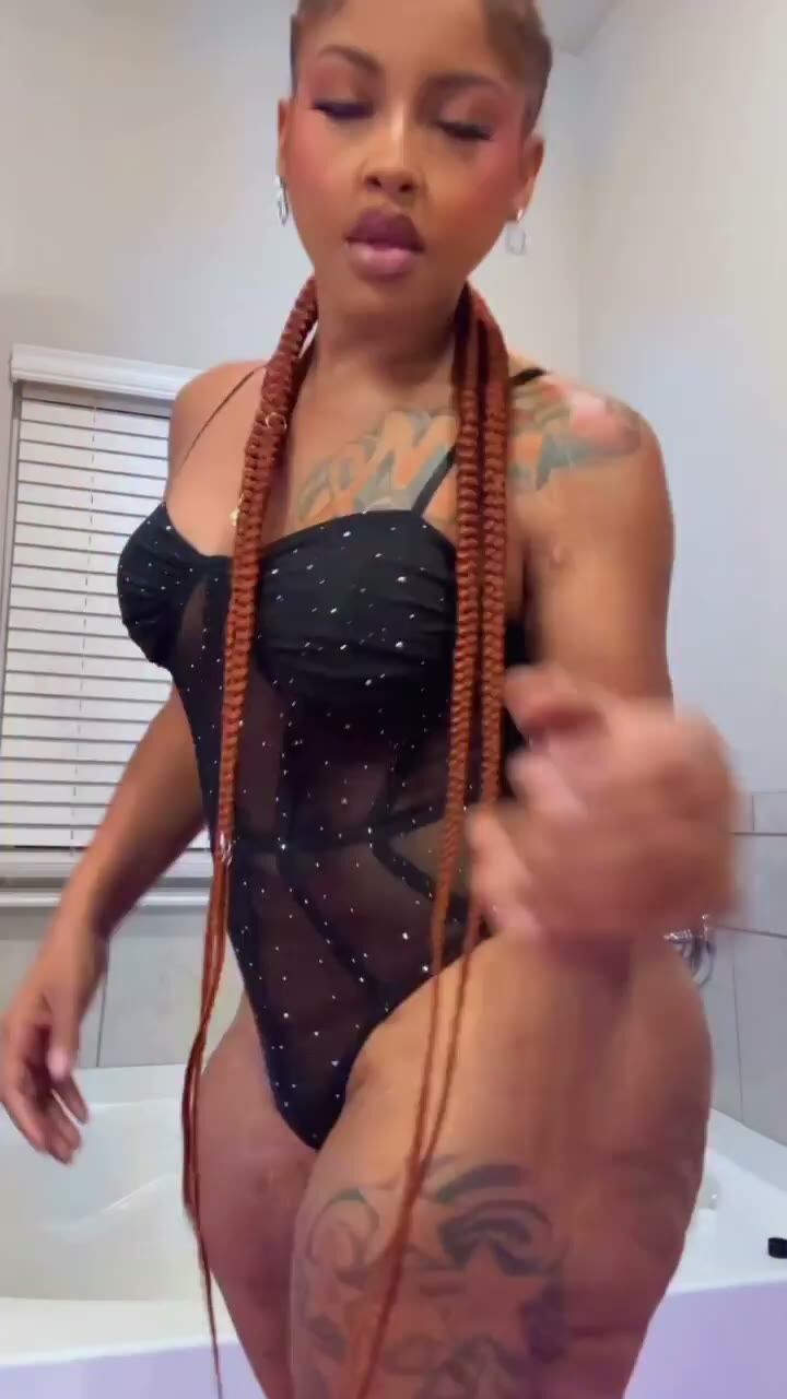 Curvy Tattooed Ebony Babe Teases in Sheer Bodysuit