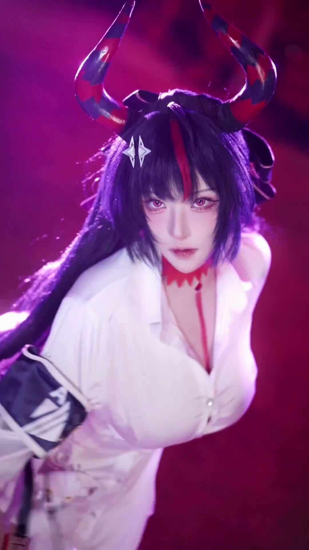 Busty Black-Haired Cosplay Babe Teases in Red Lights