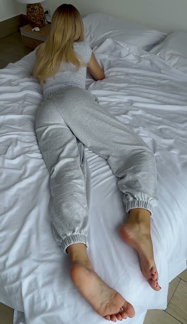 Blonde in Sweatpants Shows Soles